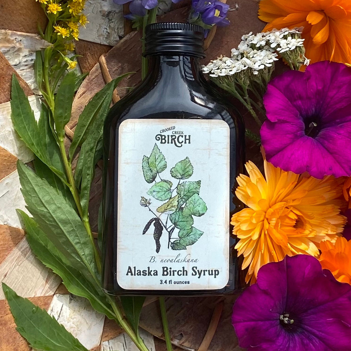 crooked creek birch syrup in birch basket wildflowers